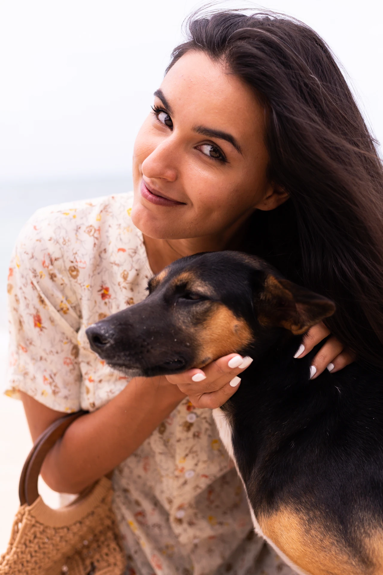 portrait-of-young-woman-holding-cute-dog